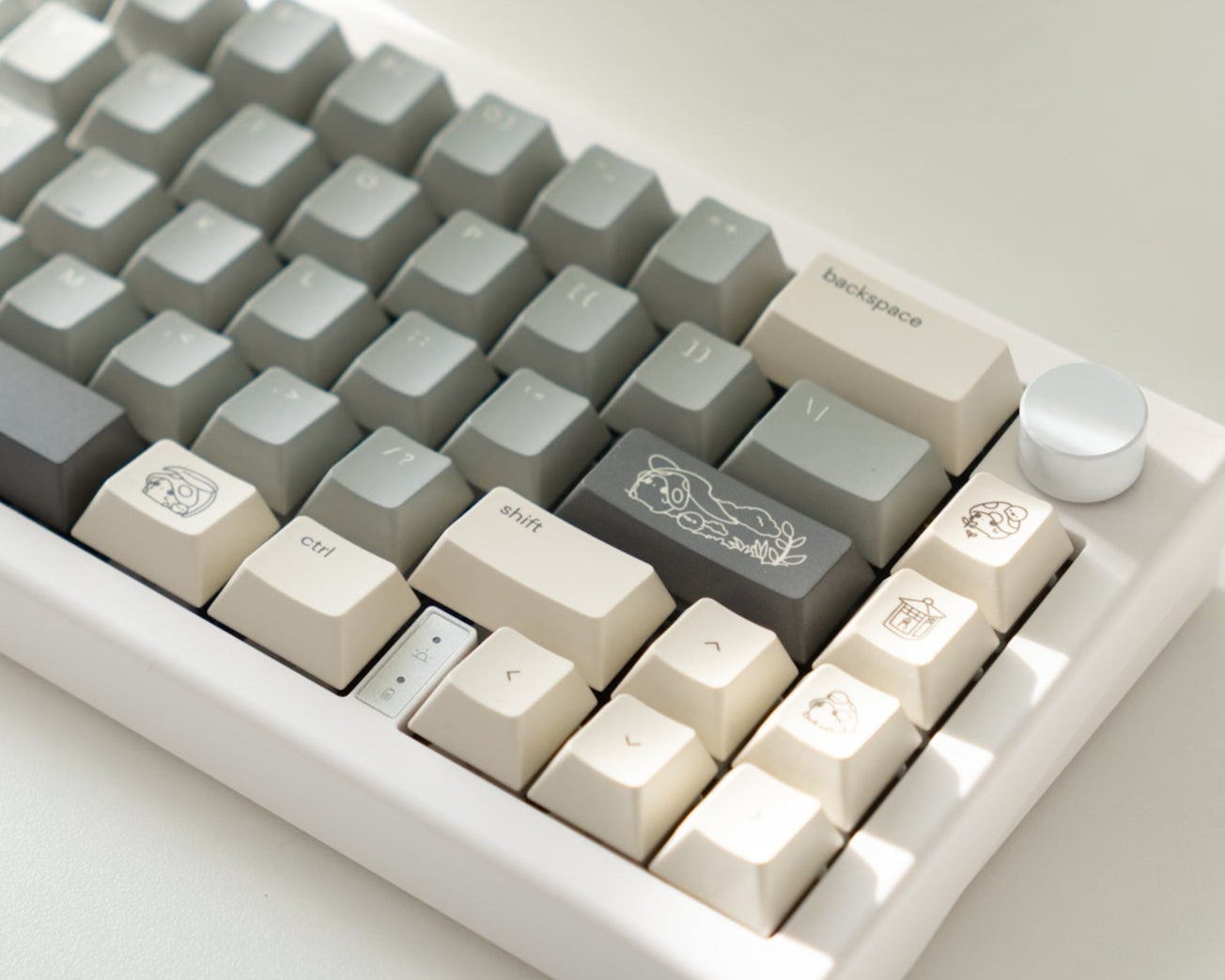 the standard mori keycaps, with mori novelty keys, on a white 65% keyboard.