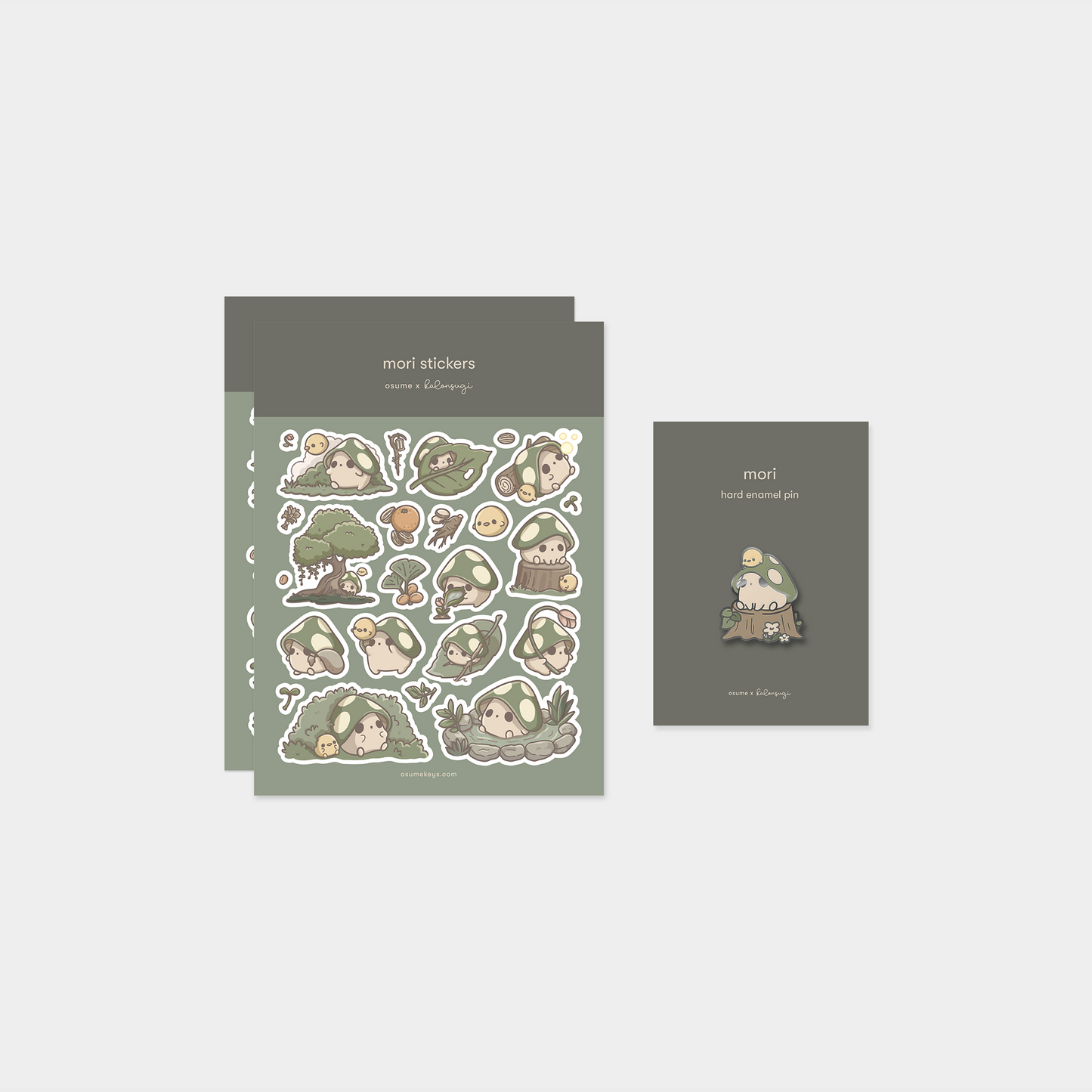 osume's mori-themed pin & sticker bundle. containing 2 sticker sheets and an enamel pin.