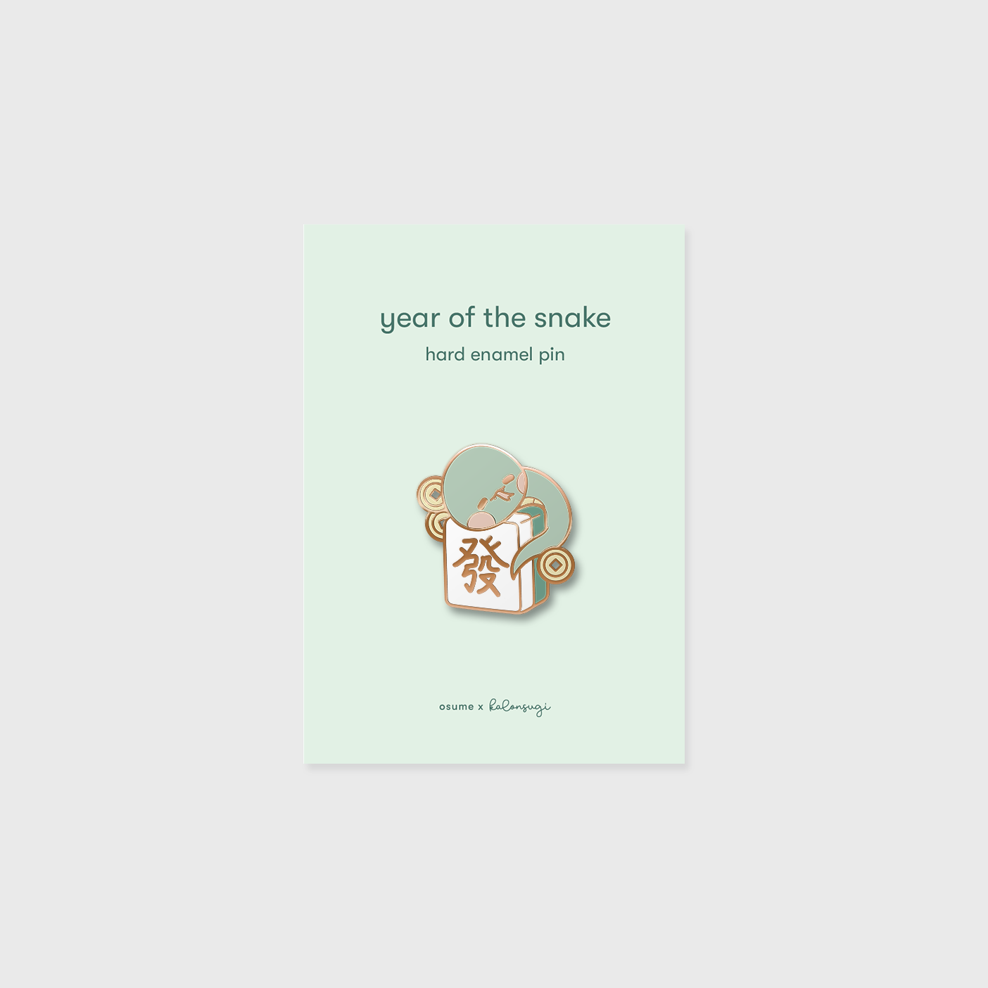 osume's year of the snake enamel pin in rose gold featuring a cute snake on a mahjong tile.