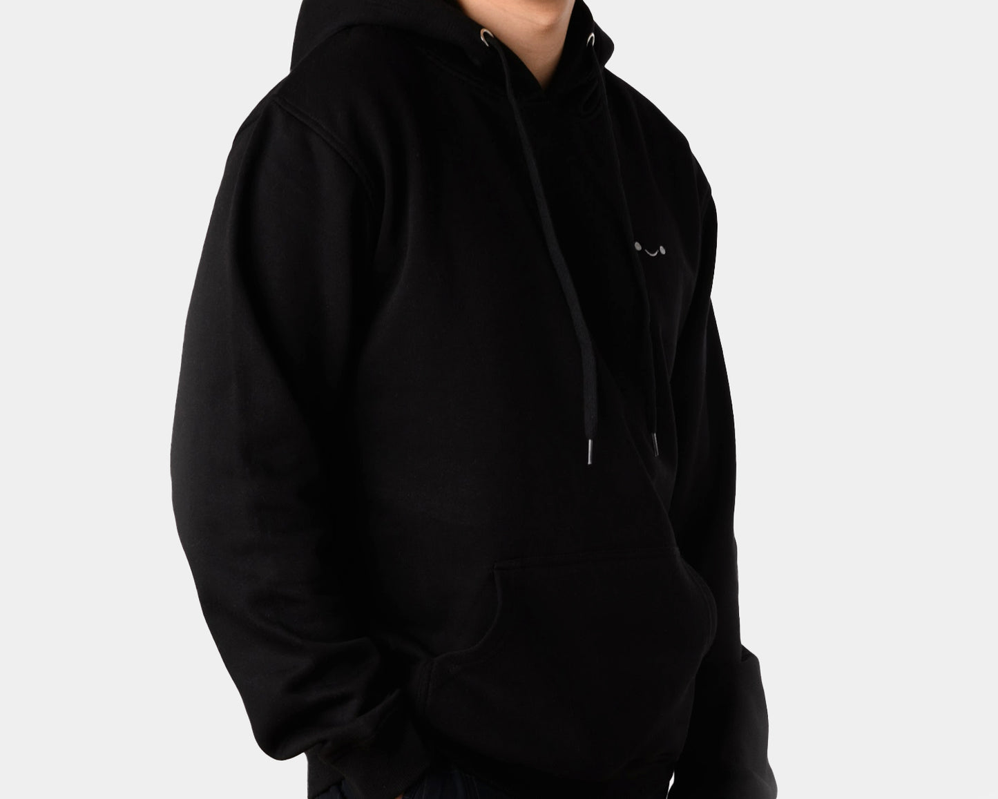 osume’s midweight hoodie in classic black featuring an embroidered white smiley face.