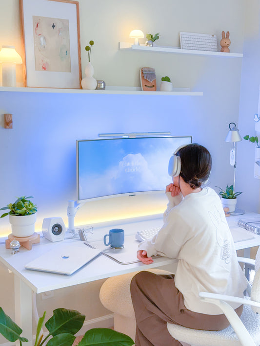 @crossingani_ sitting in her minimally designed desk. featuring yellow and blue ambient lighting.