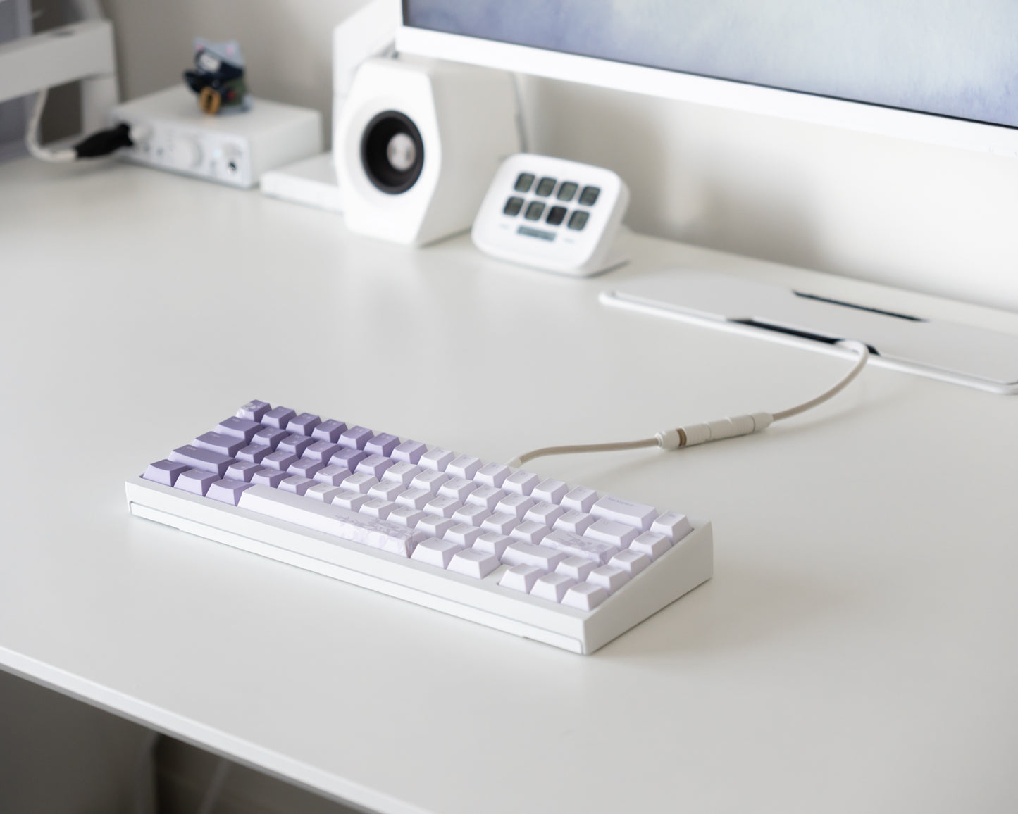 the bloom keycaps, in cangjie, on a white desk setup.