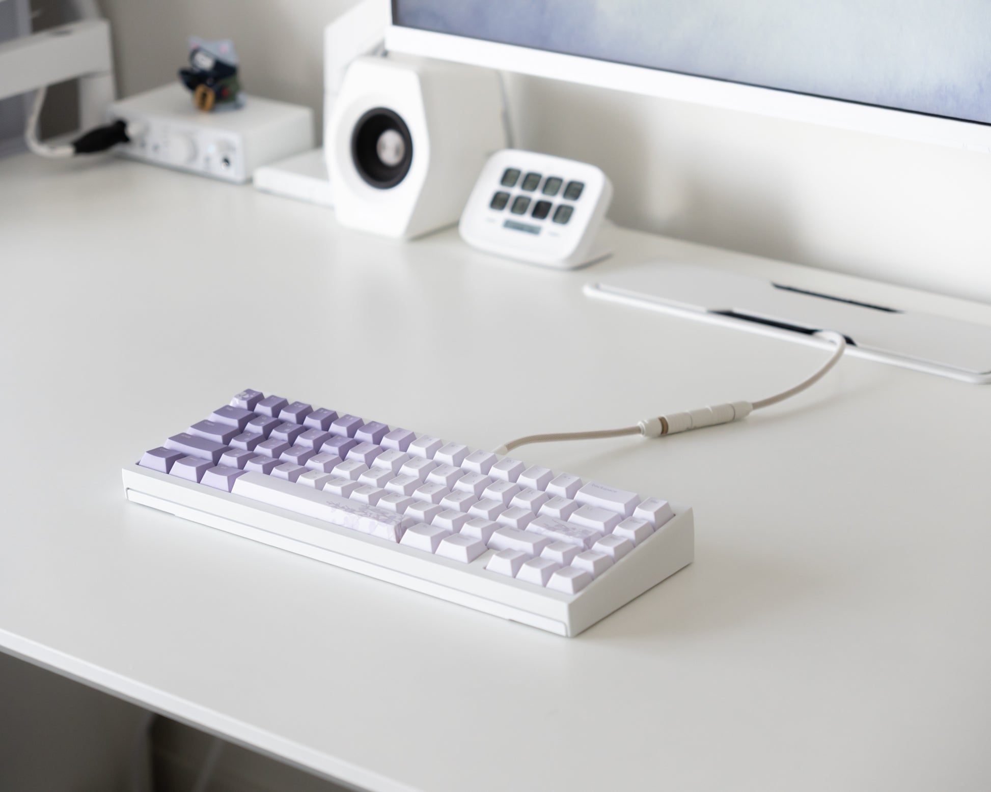 the bloom keycaps, in cangjie, on a white desk setup.