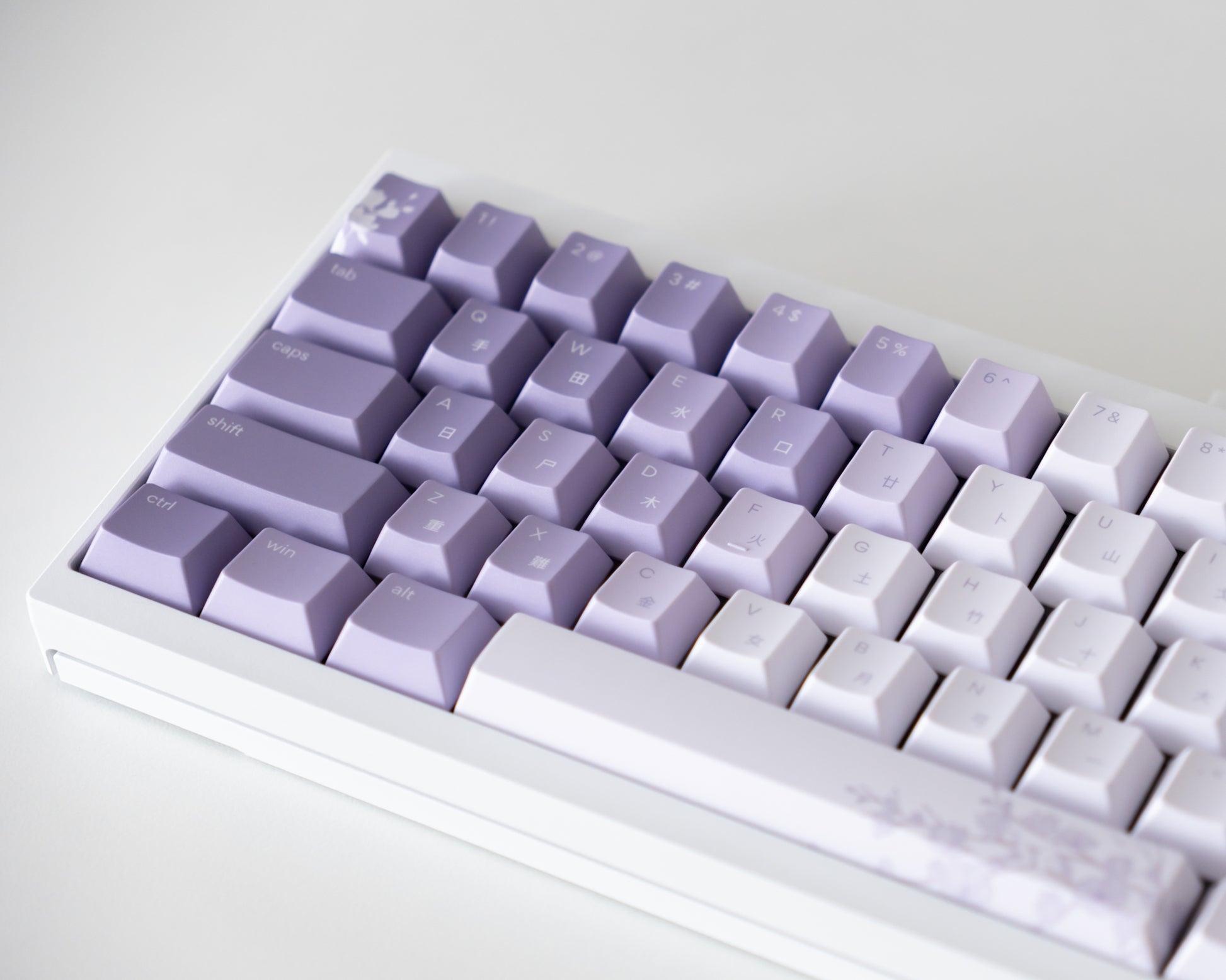 the bloom keycaps, in cangjie, on a white 60% keyboard.