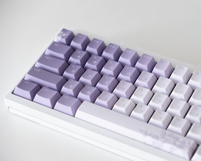 the bloom keycaps, in cangjie, on a white 60% keyboard.