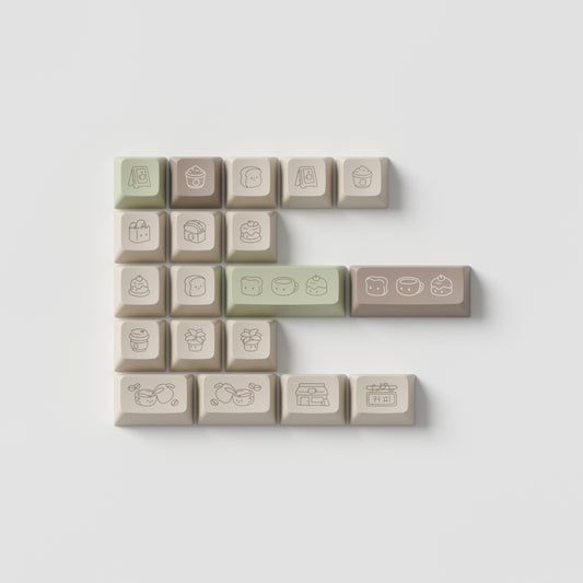 the standard edition cafe novelty keys in marshmallow profile. featuring cafe inspired artwork in spring green, roasted brown, and light stone colours.