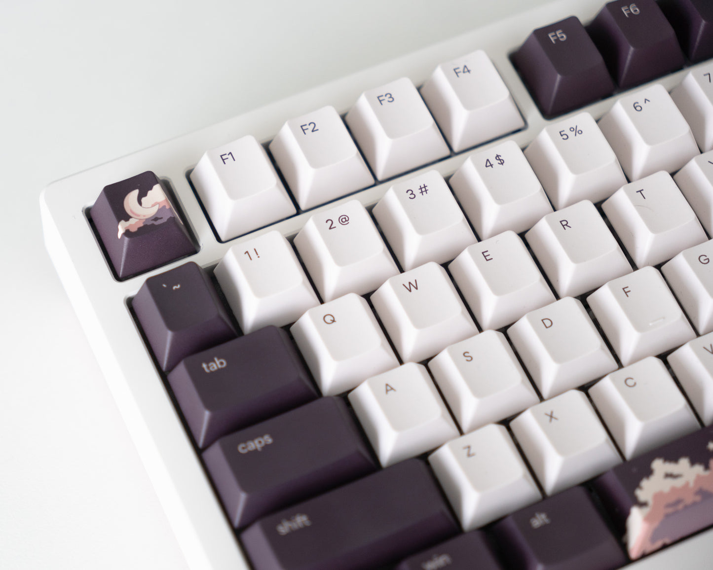 the dusk keycaps with dusk novelty keys on a white desk setup.