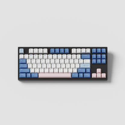 the standard konbini blue keycaps, with novelty keys, on a black tkl keyboard.