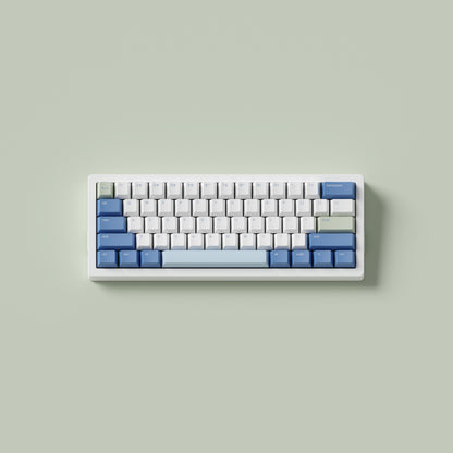 the standard konbini green keycaps, in cherry profile, on a white 60% keyboard.