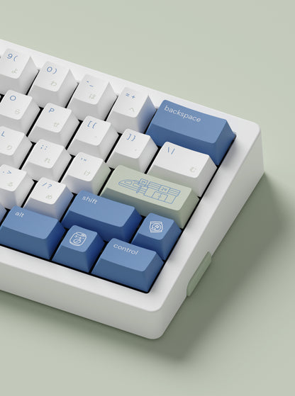 the hiragana konbini green keycaps, with novelty keys, on a white mono65 keyboard.