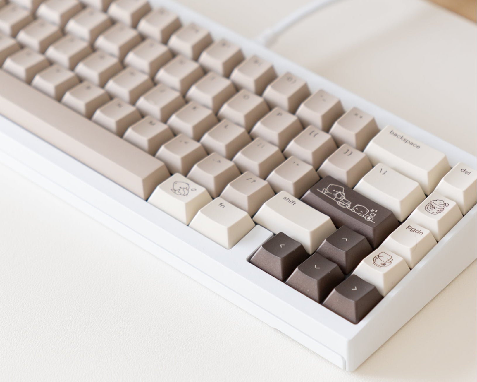the mocha keycaps, in cherry profile, on a white 60% keyboard.